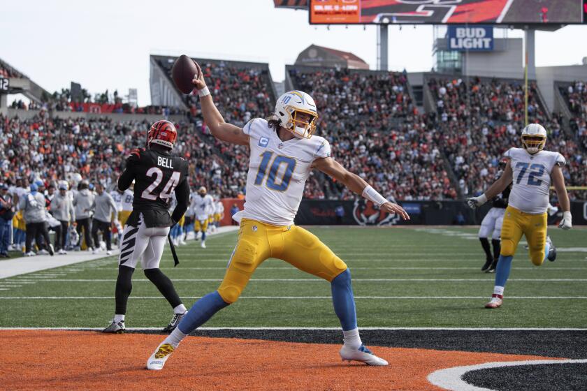 Los Angeles Chargers quarterback Justin Herbert (10) celebrates a two point conversion during an NFL football game against the Cincinnati Bengals, Sunday, Dec. 5, 2021, in Cincinnati. (AP Photo/Zach Bolinger)