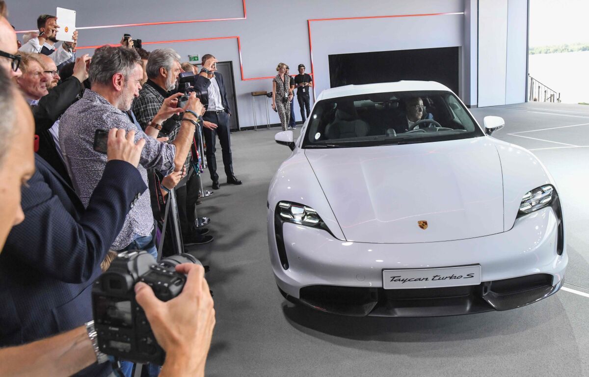 The Porsche Taycan electric car is presented during the a world premiere on Sept. 4, 2019 in a hall of the airfield in Neuhardenberg, Germany. The first pure electric model is presented at the same time on three continents and will be delivered at the end of the year, starting in the United States.
