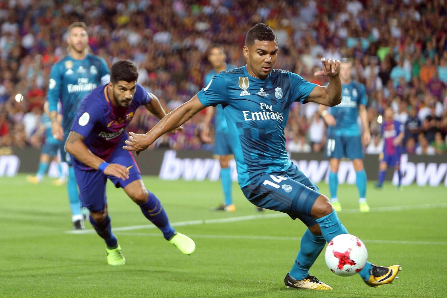 El centrocampista brasileño del Real Madrid Casemiro (d) disputa un balón con el delantero uruguayo del Barcelona (i) durante el partido de ida de la Supercopa de España. EFE
