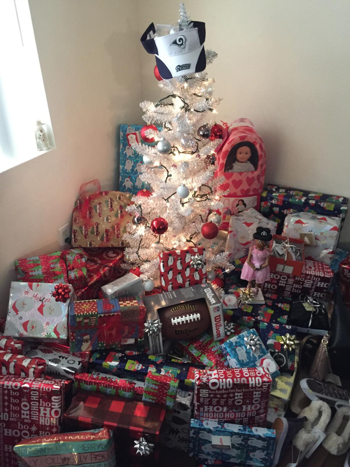 Tavon Austin and Robert Quinn purchased gifts that were wrapped and sitting beneath a small tree, ready to be opened.