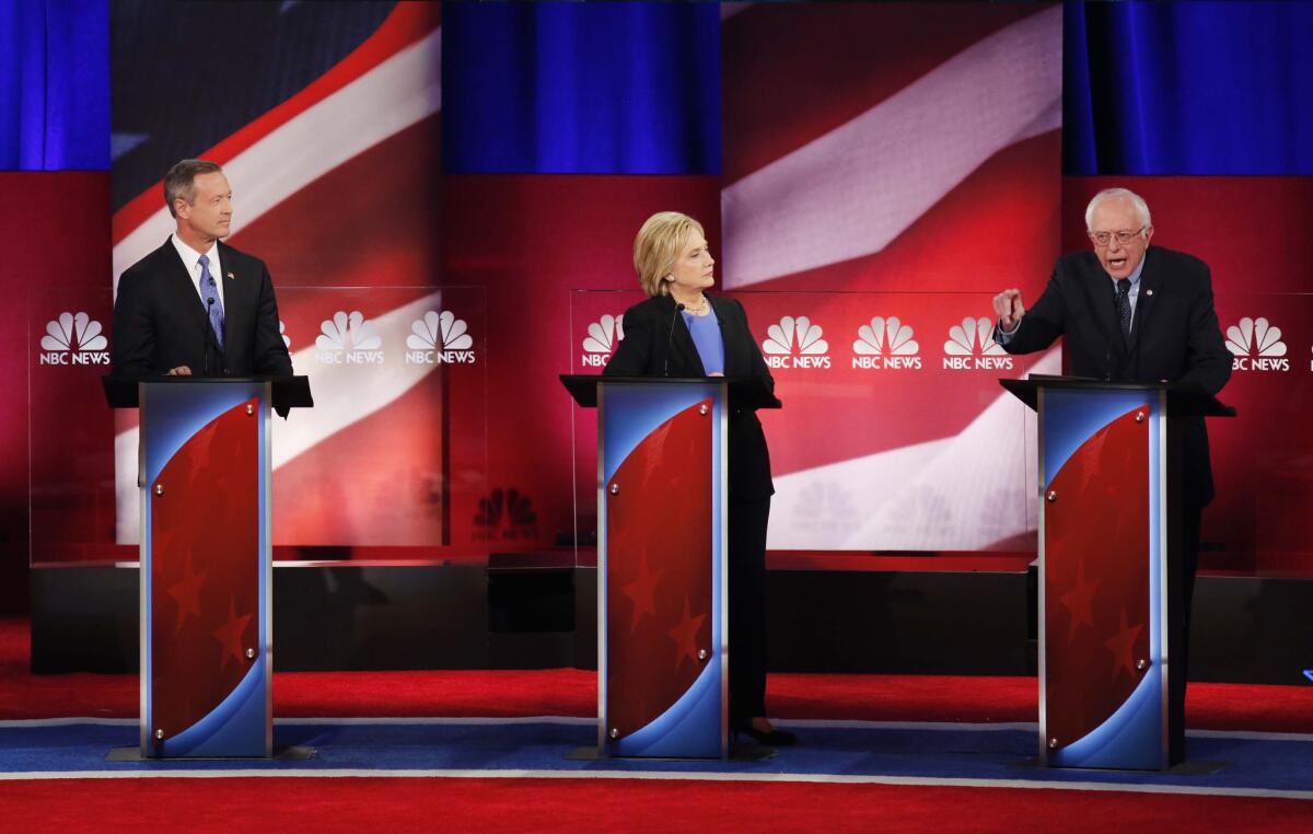 Democratic presidential candidates Martin O'Malley, left, Hillary Clinton and Bernie Sanders debate Sunday night at the Gaillard Center in Charleston, S.C.