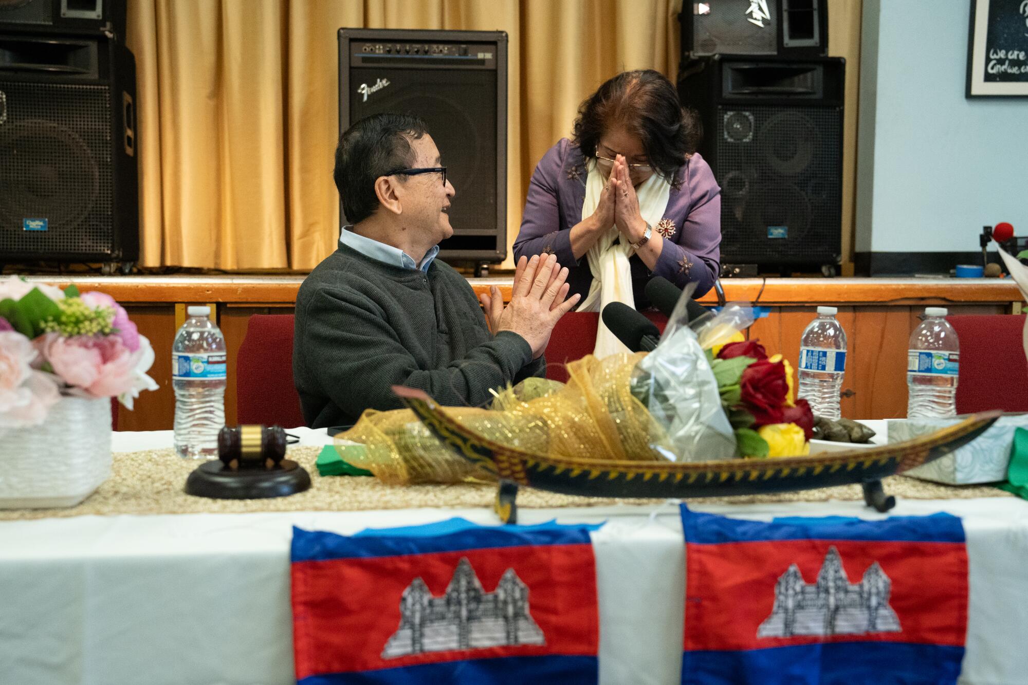 Sam Rainsy, left, greets a supporter at Bixby Knolls Christian Church.