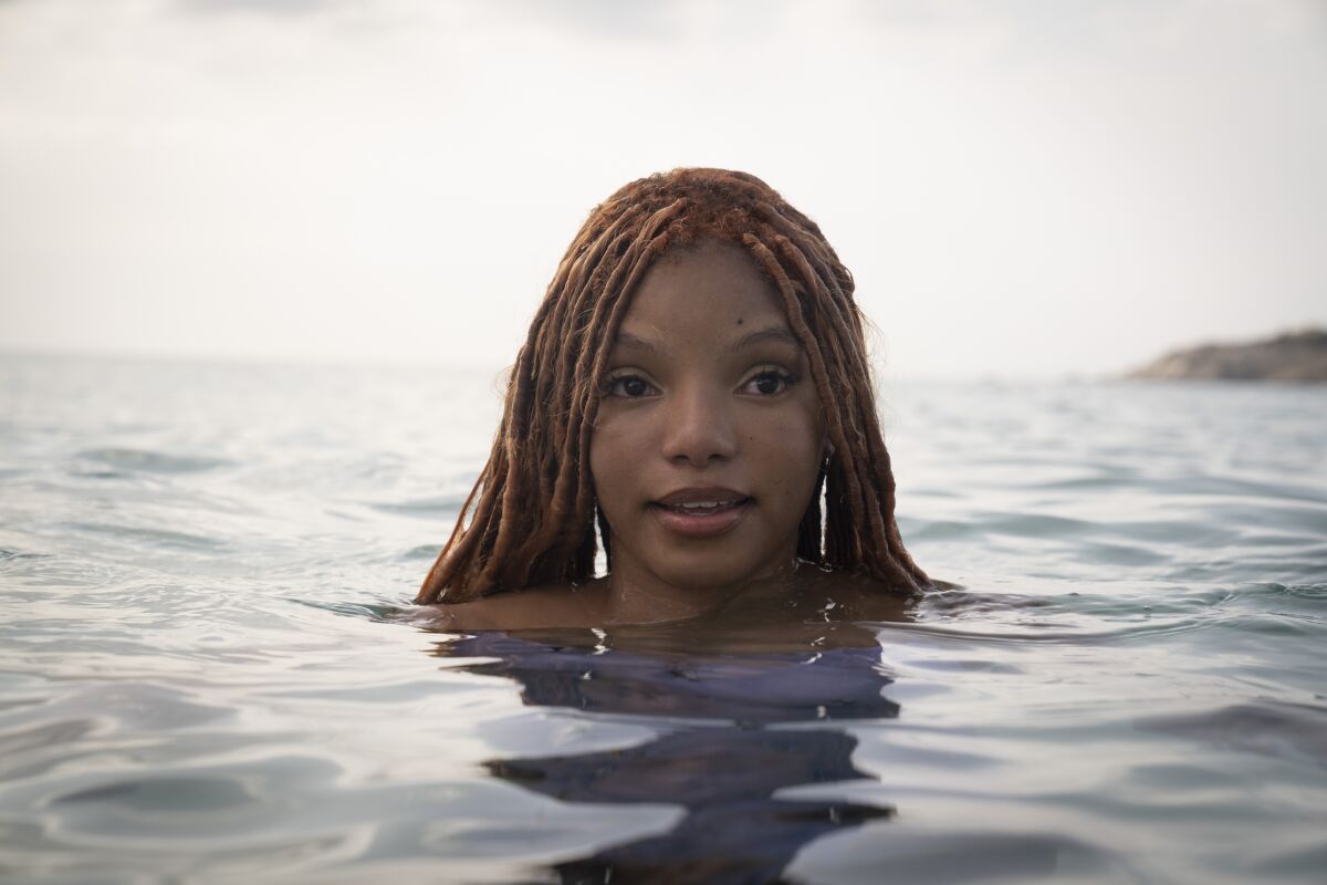 Halle Bailey looks out of the water in the movie "The Little Mermaid."