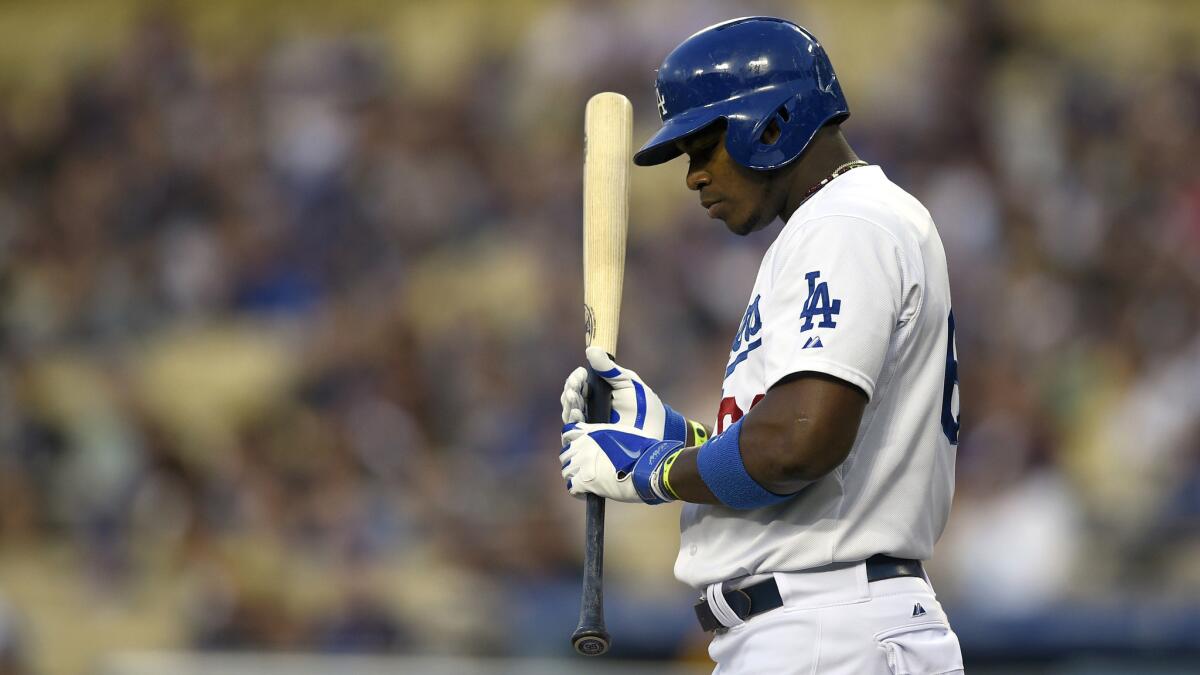 Dodgers right fielder Yasiel Puig holds his bat during an at-bat against the San Francisco Giants on Thursday. Puig denies allegations against him made in a lawsuit by man who blames Puig for his imprisonment and torture in Cuba.
