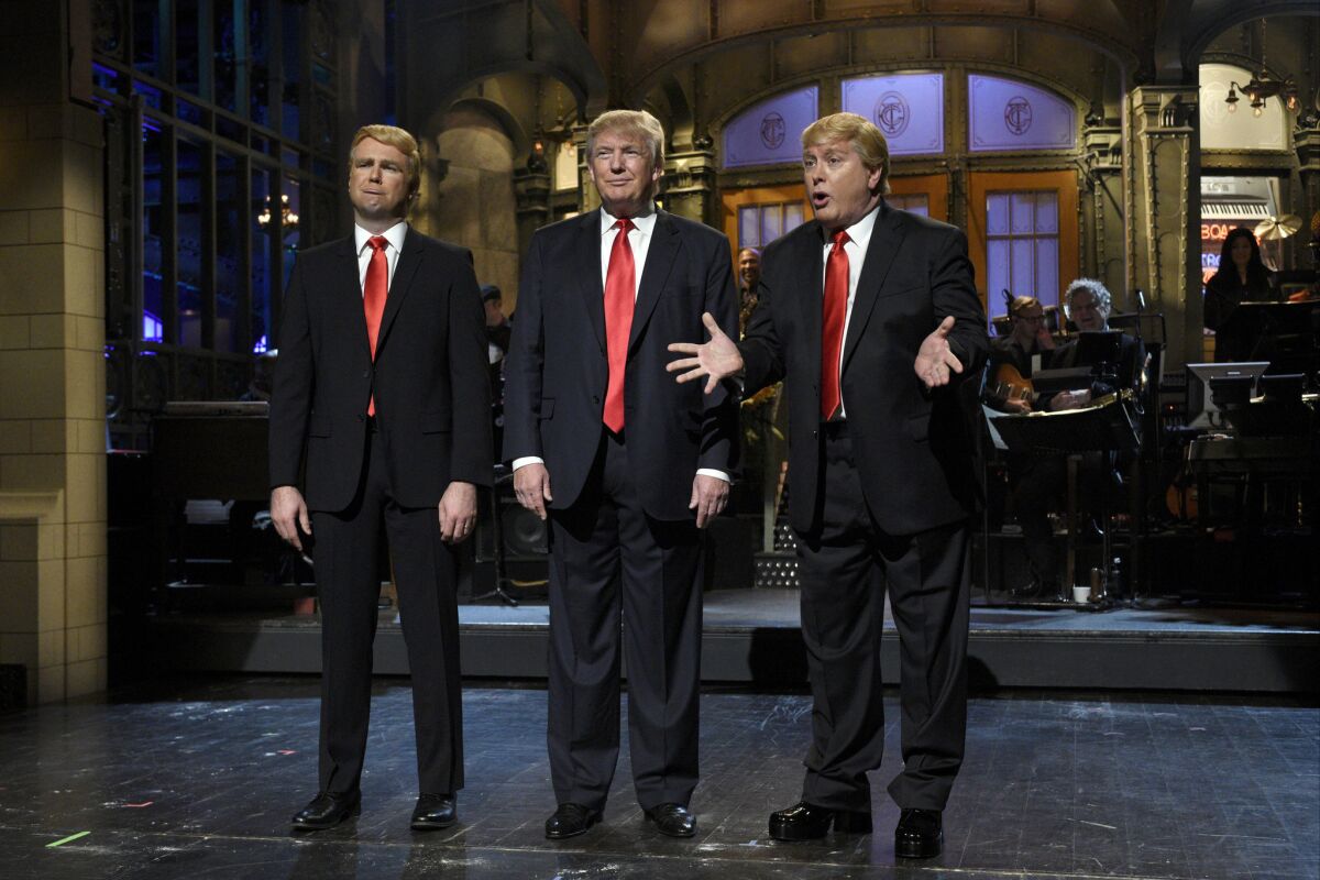 Taran Killam, left, Republican presidential candidate and guest host Donald Trump, center, and Darrell Hammond perform during the monologue on "Saturday Night Live."