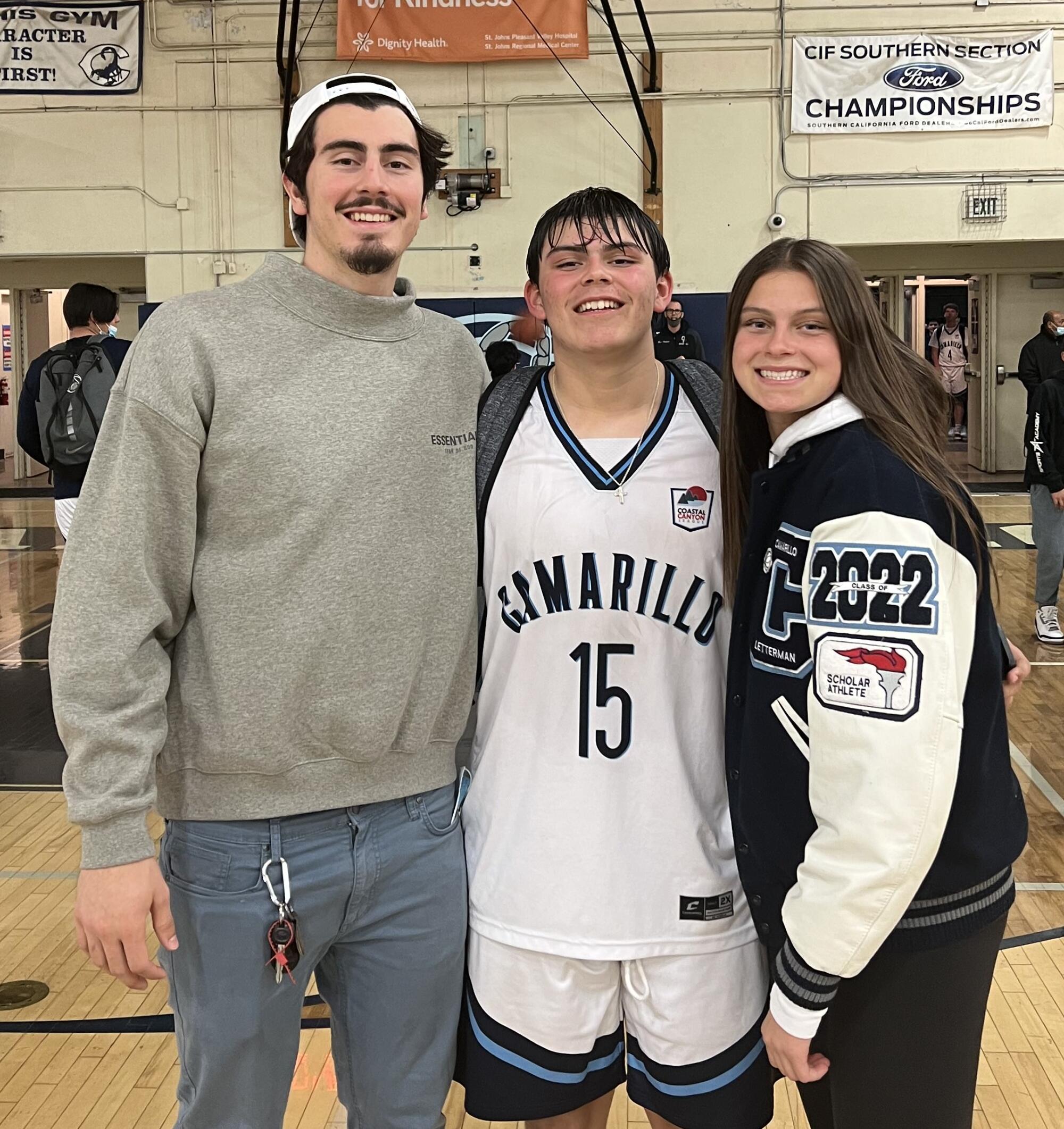 Jaime, left, Marcos and Gabriela Jaquez gather for a photo after one of Marcos' high school basketball games.
