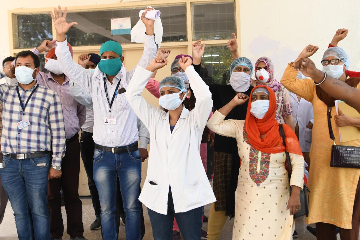 Medical staff at a hospital in Amritsar, India, protest a lack of protective gear and coronavirus testing kits Friday.