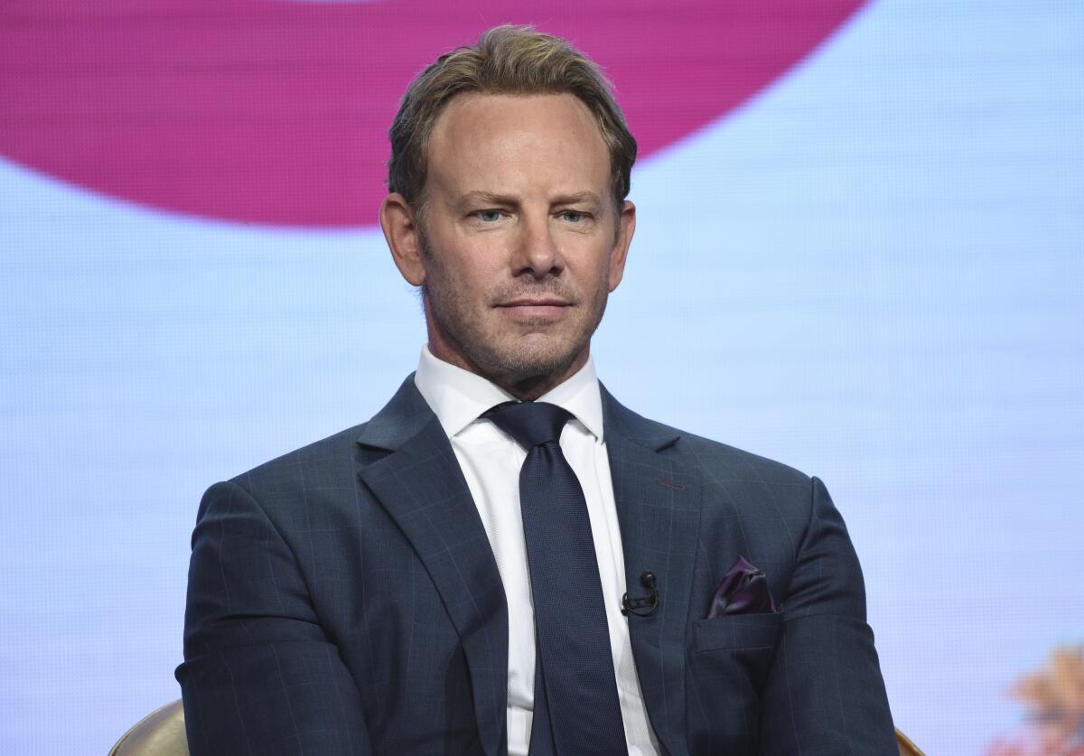 Ian Ziering in a dark blue suit and tie.