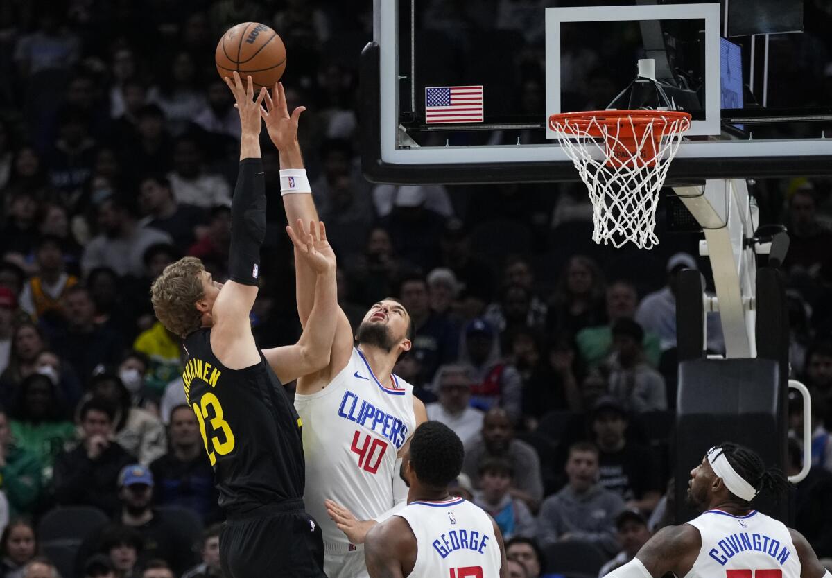 Clippers center Ivica Zubac stretches out to block a shot by Jazz forward Lauri Markkanen 