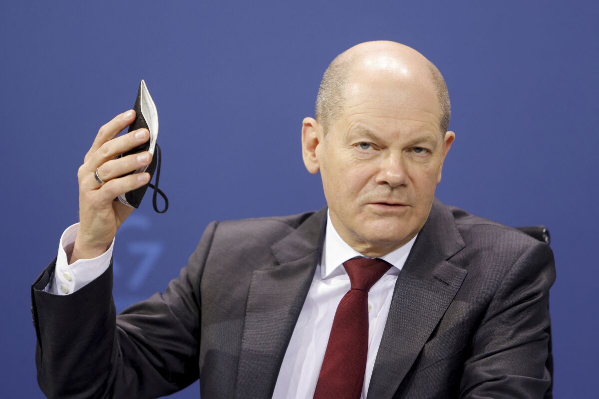 German Chancellor Olaf Scholz addressed the media after a meeting with the federal state governors on measures to battle the coronavirus pandemic at the chancellery in Berlin, Germany, Wednesday, Feb. 16, 2022. (Michele Tantussi/Pool via AP)