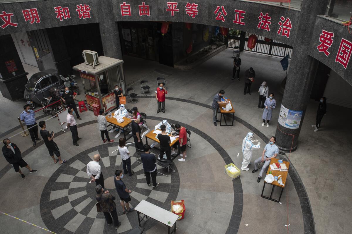 People wait for coronavirus tests May 13, 2020. The lockdown on Wuhan lasted about three months, until April 8.