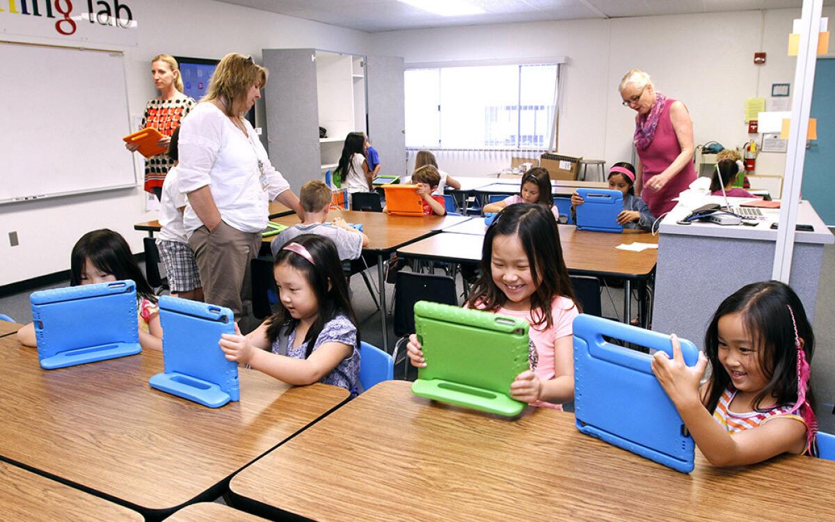 First graders at Palm Crest Elementary School's iPad Learning Lab learn how to use new apps for the iPad in La Canada Flintridge on Tuesday, April 8, 2014. The school district recently opened 3 elementary school iPad Learning Labs with donations from the Educational Foundation.
