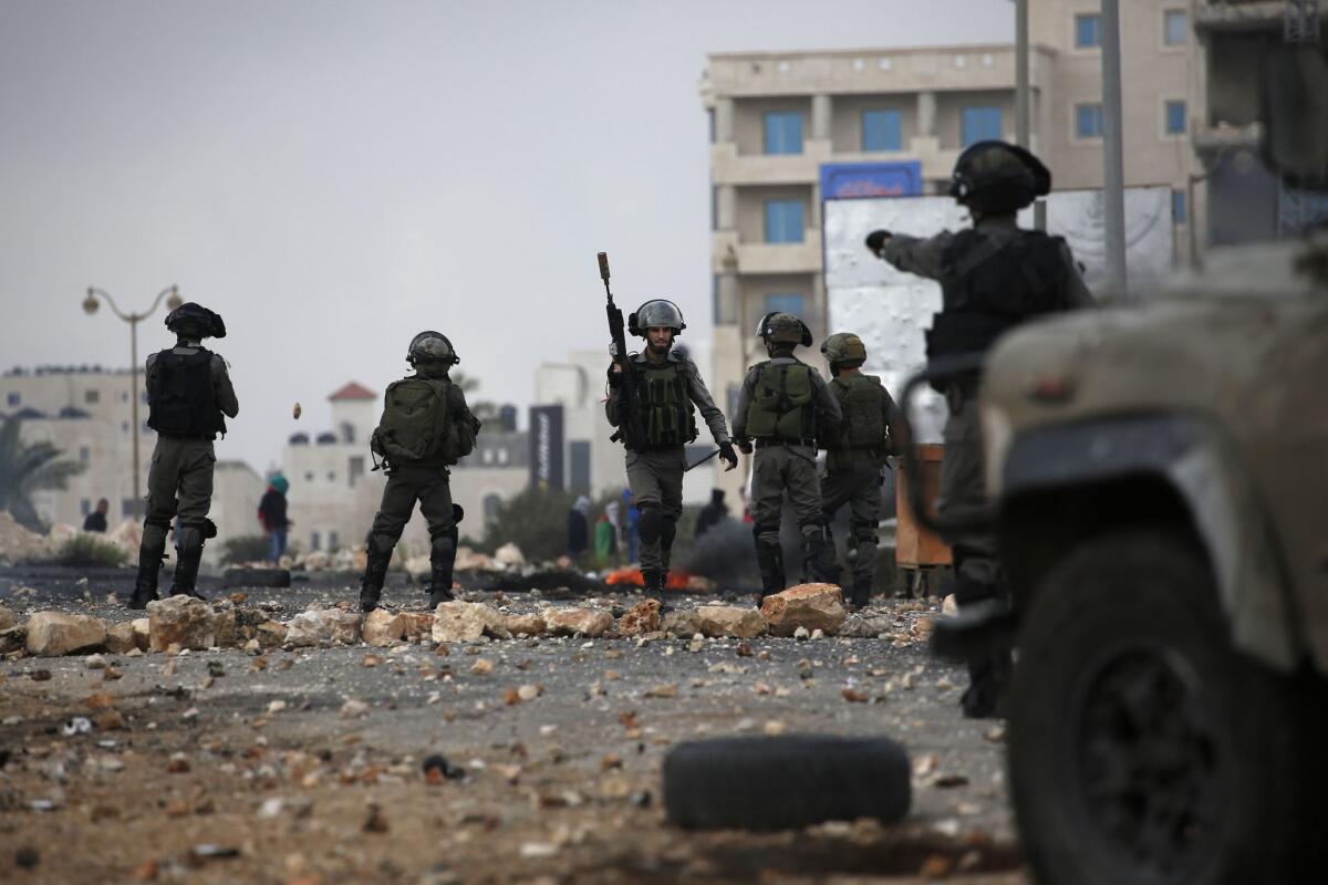 Israeli security forces hold a position during clashes with Palestinian stone-throwers in Beit El, on the outskirts of the West Bank city of Ramallah, on Oct. 7, 2015.