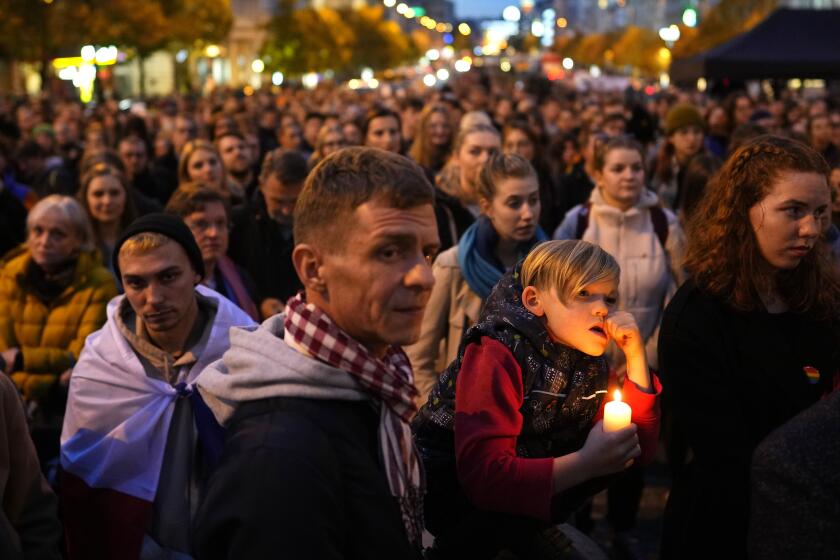 People gather in support of LGBTQ community in Prague, Czech Republic, Wednesday, Oct. 26, 2022. Thousands of people rallied in the Czech capital on Wednesday to honor two Slovak gay men that were shot dead in Bratislava and demand a better protection of the LGBTQ community. (AP Photo/Petr David Josek)