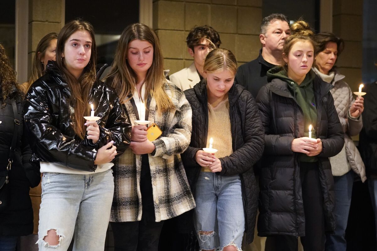 Students hold candles and attend a vigil 