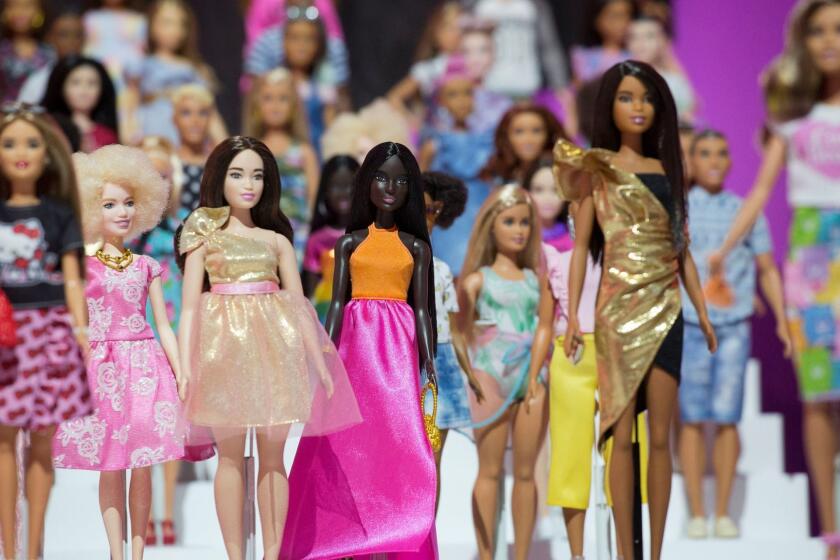 FILE- In this Feb. 20, 2018, file photo dozens of Barbie dolls are displayed at the Mattel showroom at Toy Fair in New York. Mattel reports earnings Thursday, April 26. (AP Photo/Mark Lennihan, File)
