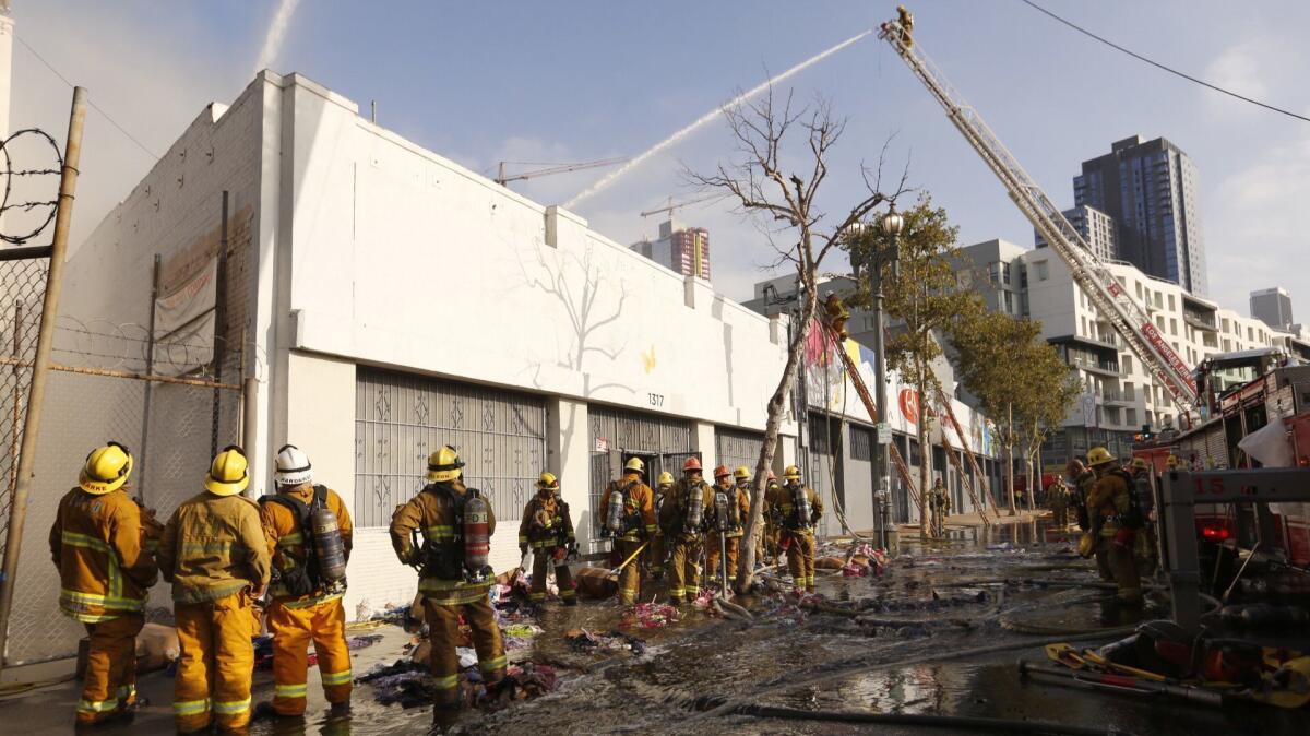 Los Angeles city firefighters battle a greater alarm structure fire in a commercial building in downtown Los Angeles on Wednesday morning.