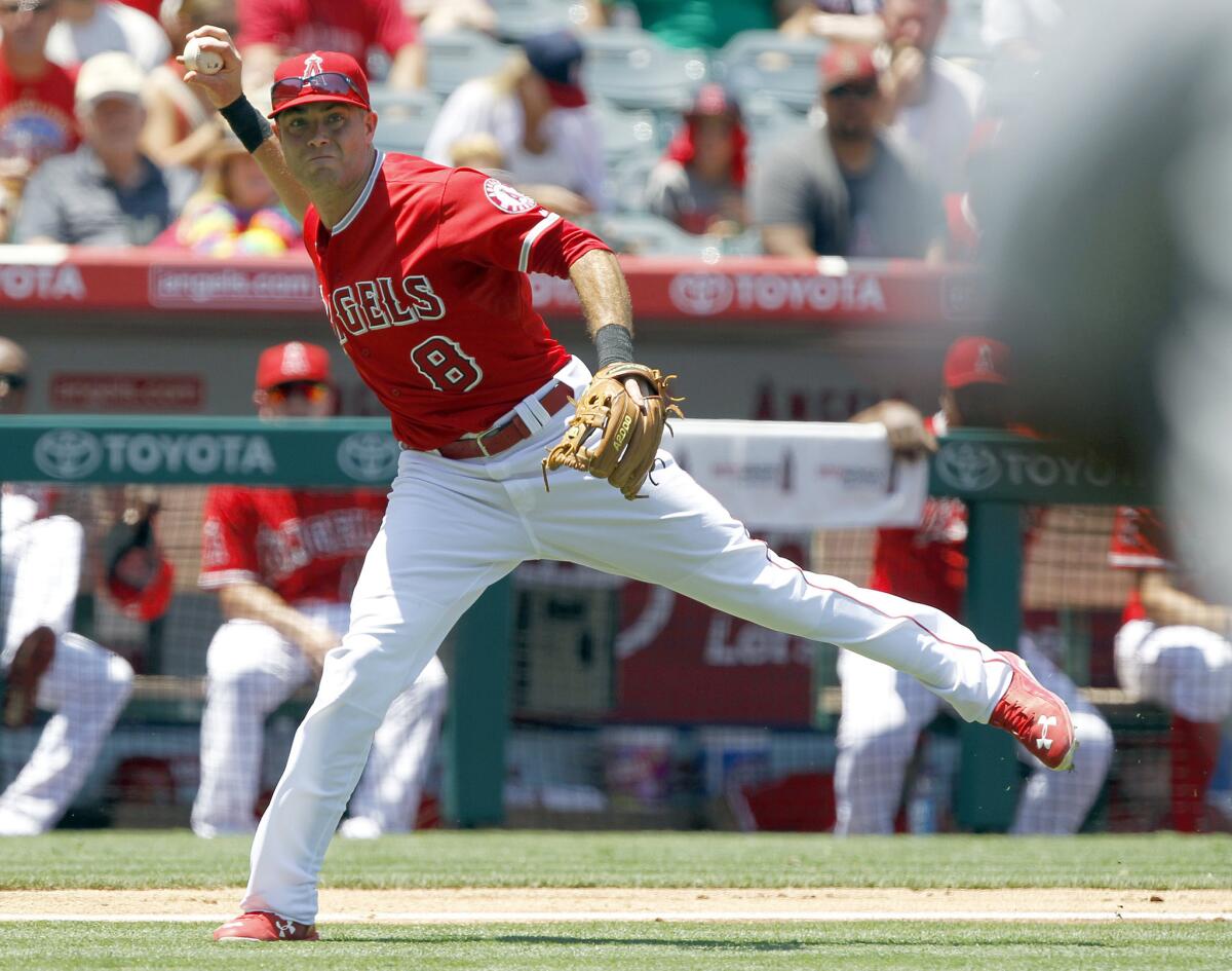 Angels third baseman Taylor Featherston throws out a Twins batter attempting to bunt during the fourth inning on July 23, 2015.
