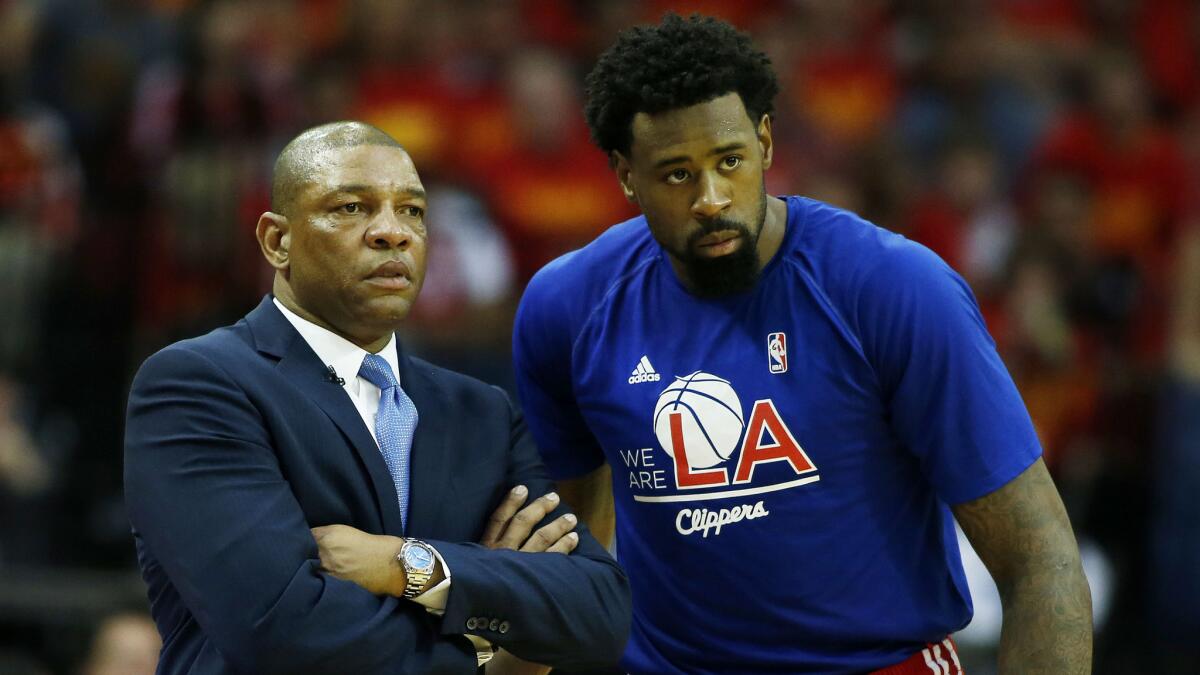 Clippers Coach Doc Rivers, left, speaks with center DeAndre Jordan during the Clippers' season-ending loss to the Houston Rockets in Game 7 of the Western Conference semifinals on May 17.