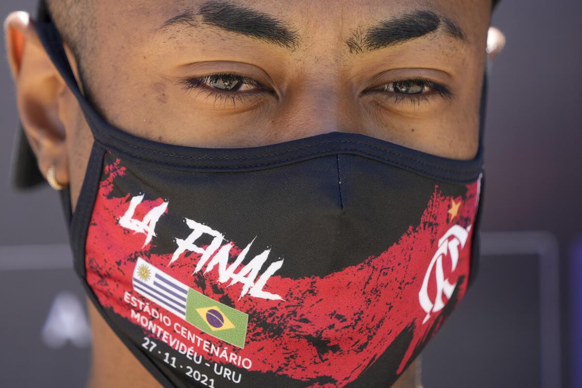 Bruno Henrique of Brazil's soccer team Flamengo talks to press upon arrival to the airport in Montevideo, Uruguay, Wednesday, Nov. 24, 2021. Flamengo will face Brazilian rival team Palmeiras for the Copa Libertadores final on Nov. 27. (AP Photo/Natacha Pisarenko)