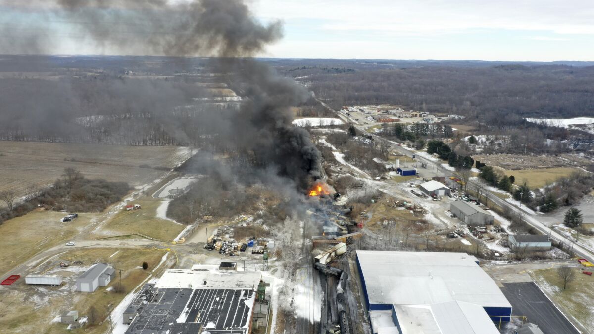 FILE - This photo taken with a drone shows portions of a Norfolk and Southern freight train that derailed Friday night in East Palestine, Ohio are still on fire at mid-day Saturday, Feb. 4, 2023. The federal government filed a lawsuit Thursday, March 30, against railroad Norfolk Southern over environmental damage caused by a February derailment on the Ohio-Pennsylvania border that spilled hazardous chemicals into nearby creeks and rivers. (AP Photo/Gene J. Puskar, File)