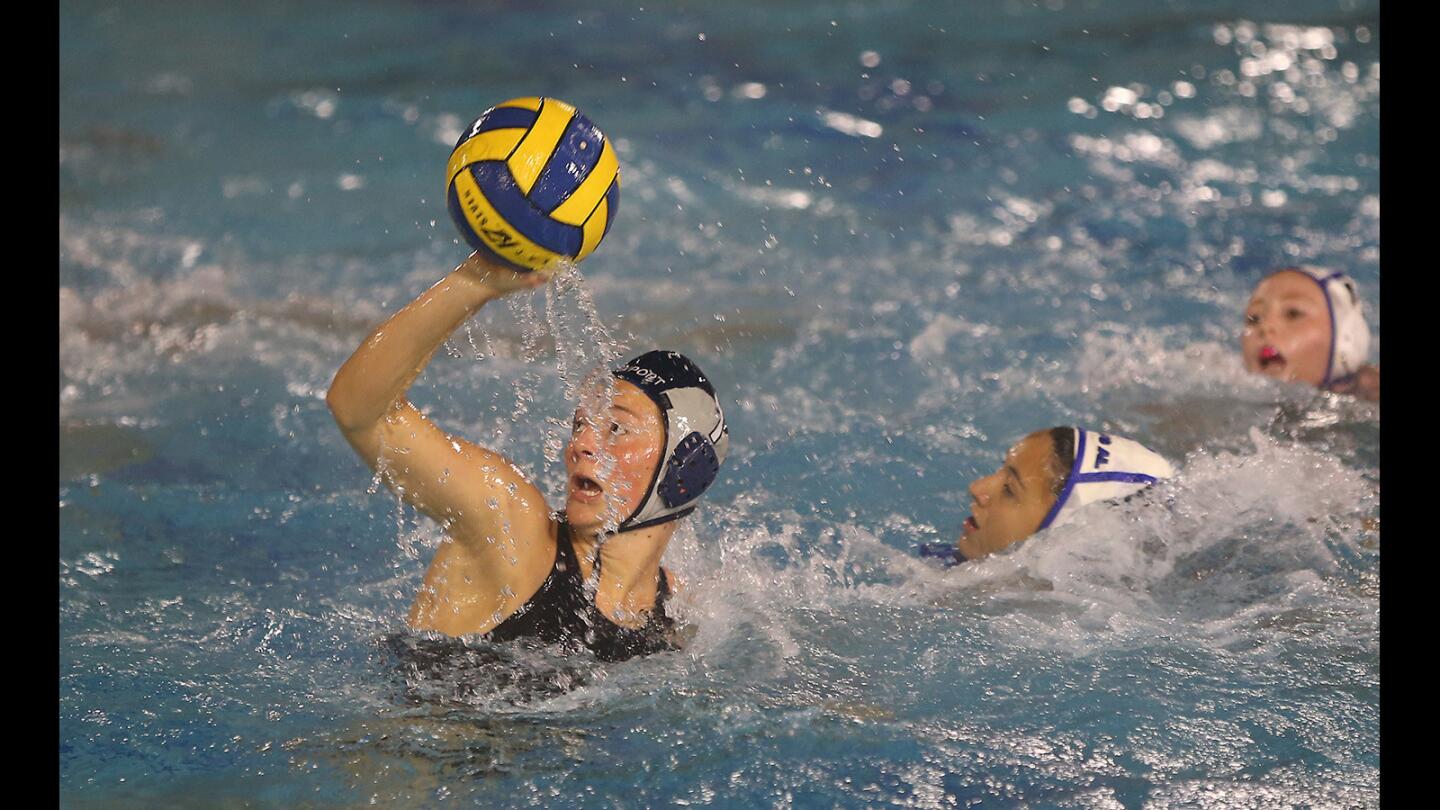 Newport Harbor's Anne Rankin makes a move in front of the net for a score in girls' water polo action against Los Alamitos on Wednesday.