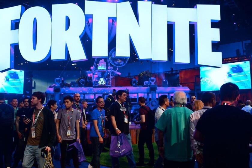 (FILES) This file photo taken on June 12, 2018 shows people crowding the display area for the survival game Fortnite at the 24th Electronic Expo, or E3 2018, in Los Angeles, where hardware manufacturers, software developers and the video game industry present their new games. - Fortnite's popularity took off last year after the release of a free "battle royale" version that lets up to 100 players vie to be the last character standing on ever-shrinking terrain. Dropped onto the battlefield with nothing, players have to scrounge for weapons as the fight for survival begins. (Photo by Frederic J. BROWN / AFP)FREDERIC J. BROWN/AFP/Getty Images ** OUTS - ELSENT, FPG, CM - OUTS * NM, PH, VA if sourced by CT, LA or MoD **