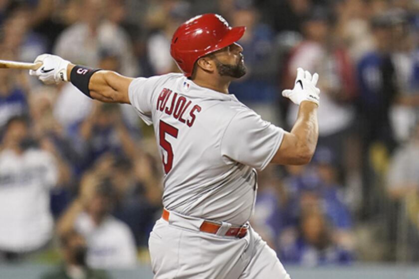 The Cardinals' Albert Pujols watches his home run during the fourth inning against the Dodgers.