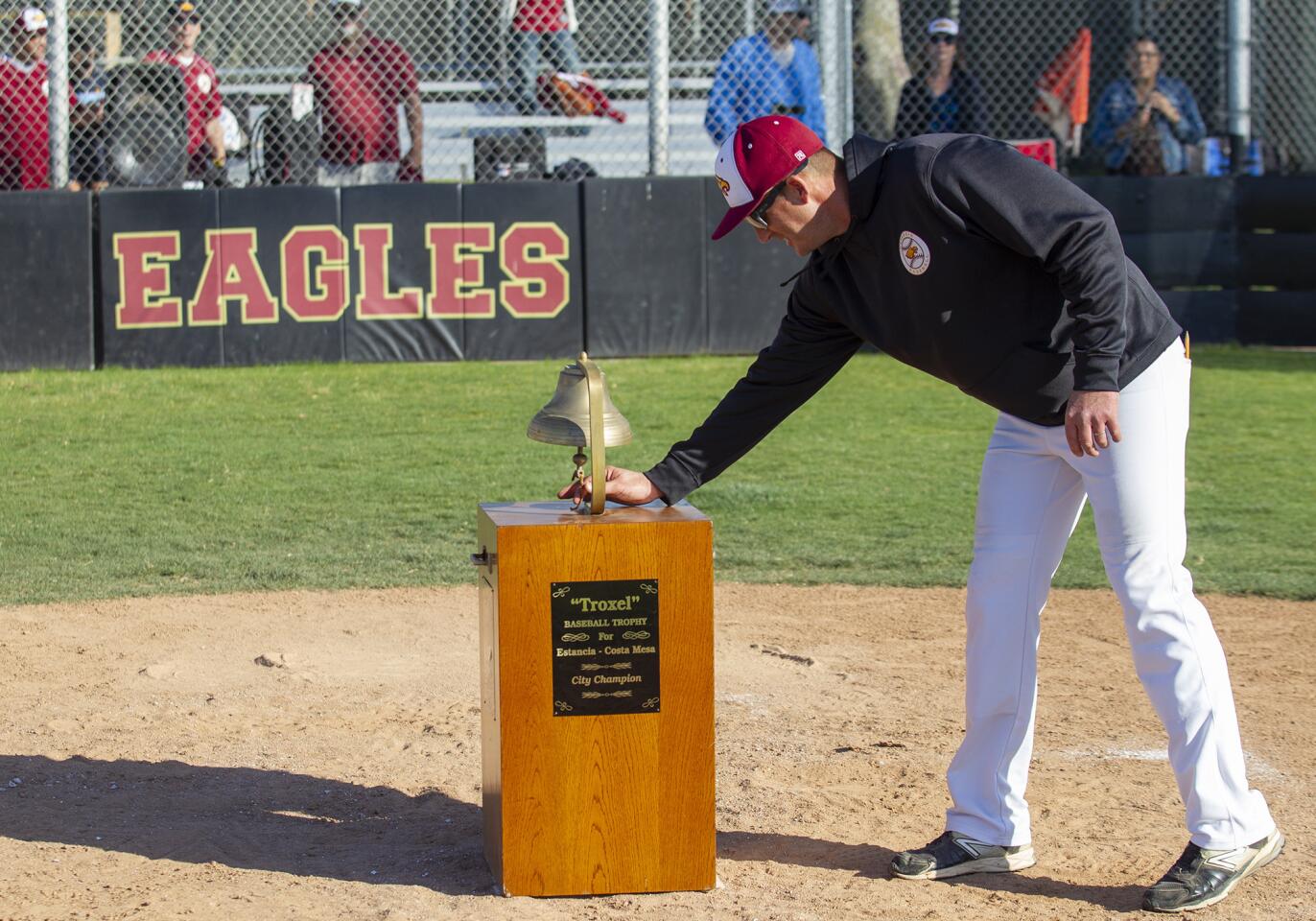 Estancia coach Kevin Conlin rings the Paul Troxel trophy after beating Costa Mesa 3-2 in an Orange Coast League game on Wednesday.