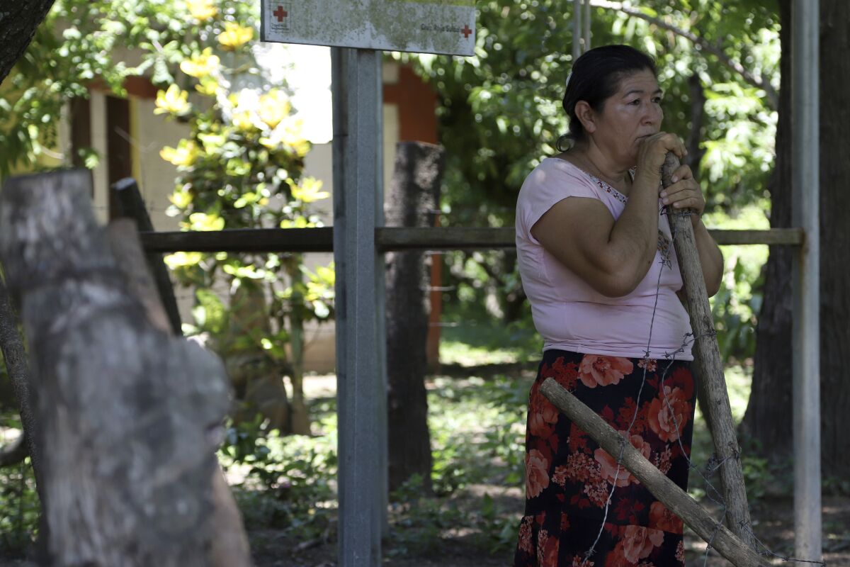 Maria Dolores Garcia, the mother of Esmeralda Dominguez, looks out at the plants dying in her daughter’s unattended garden, in the Sisiguayo community in Jiquilisco, in the Bajo Lempa region of El Salvador, Thursday, May 12, 2022. Her daughter is among thousands arrested since the congress granted President Nayib Bukele a state of emergency declaration suspending civil liberties after street gangs killed dozens of people in late March. (AP Photo/Salvador Melendez)
