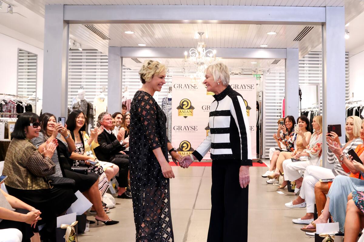 Kelly Gray and Marie St. John Gray on runway at their July 29 Grayse fashion show in partnership with Asian Hall of Fame. 