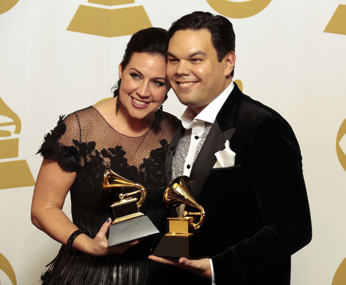 Kristen Anderson-Lopez and Robert Lopez hold up their award for song written for visual media for "Let It Go."