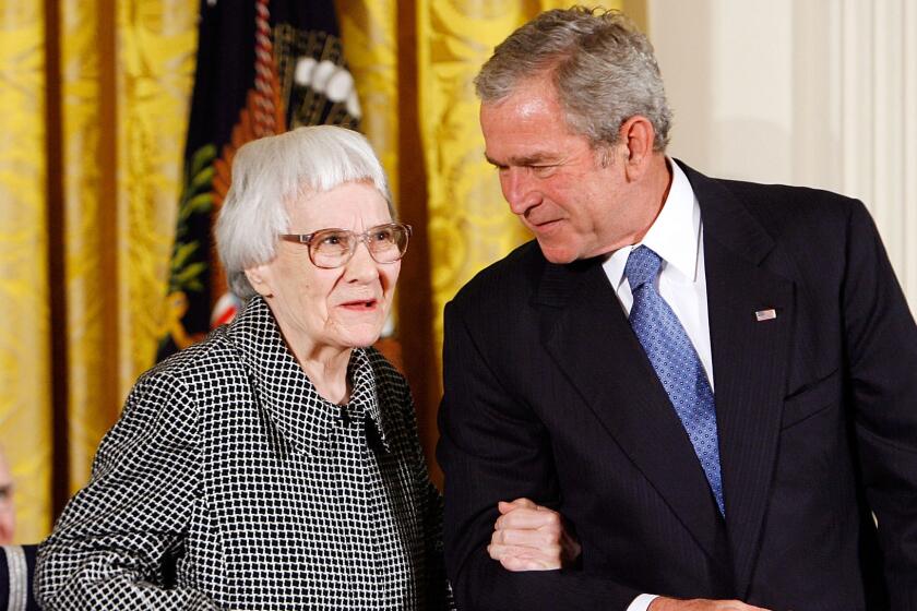 Harper Lee with President George W. Bush in 2007. Letters Lee wrote -- including one complainging about Donald Trump's casino -- are up for auction.