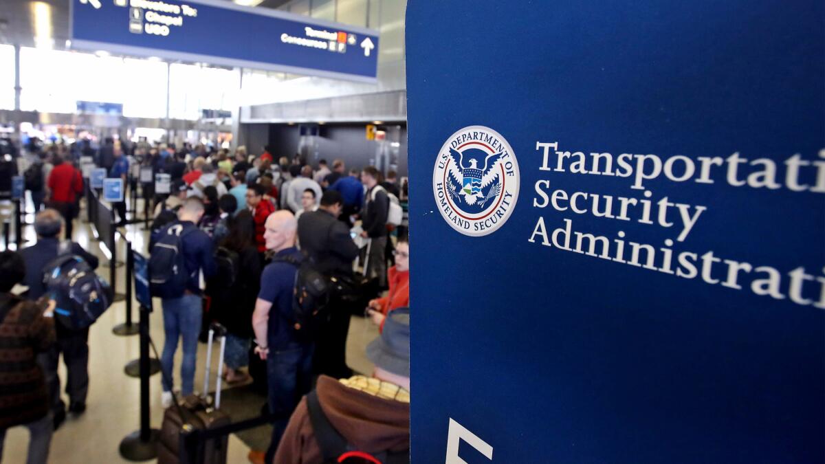 Passengers at Chicago O'Hare International Airport wait in line to be screened at a Transportation Security Administration checkpoint in May. The TSA hired new screeners, promoted others and redeployed some agents to keep lines moving this summer.