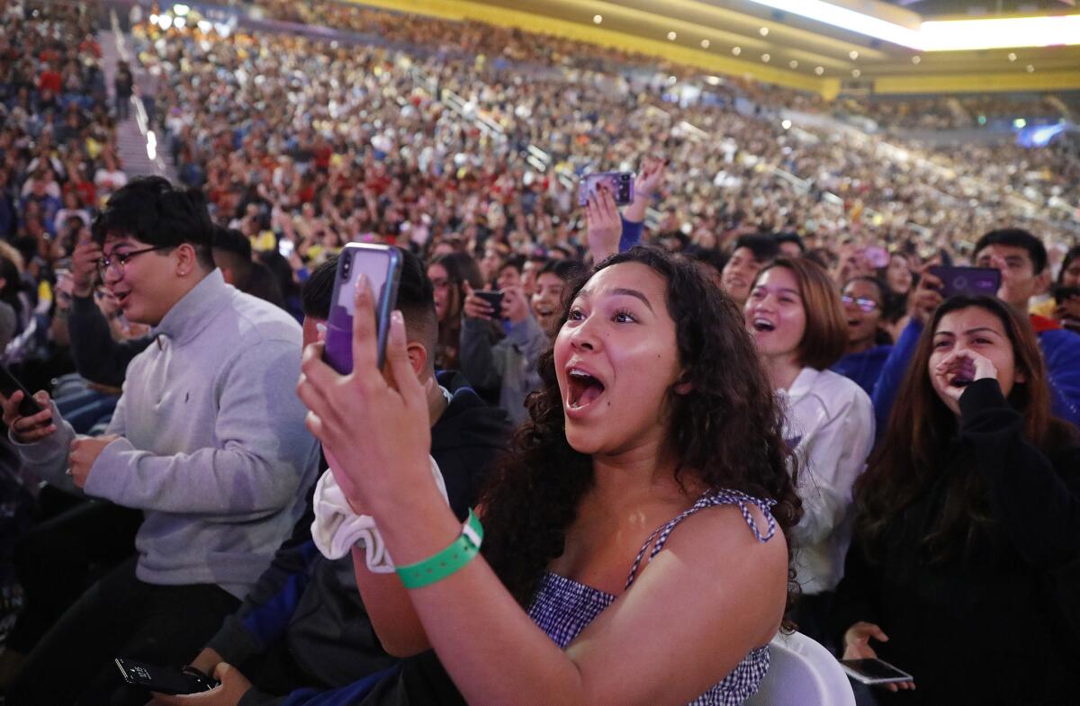 Christina Furumasu, center, from Western High School, reacts to Michelle Obama onstage.