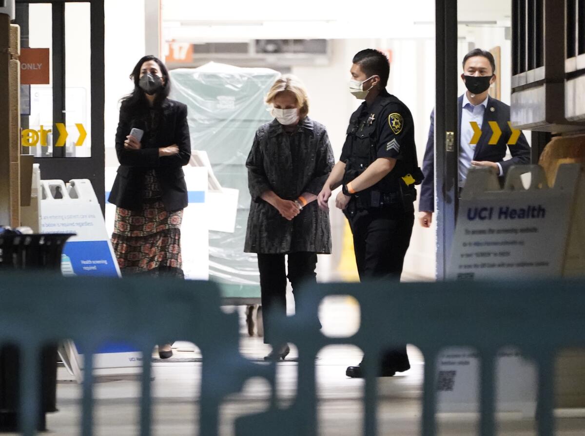 Former Secretary of State Hillary Clinton exits the UC Irvine Medical Center after visiting former President Bill Clinton. 