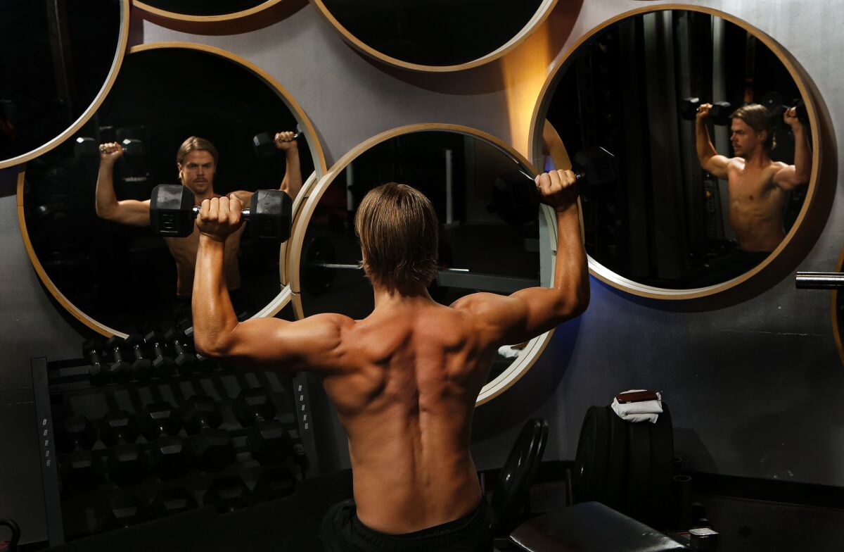 Derek Hough does a shoulder exercise at Pulse Fitness Studio in Sherman Oaks.