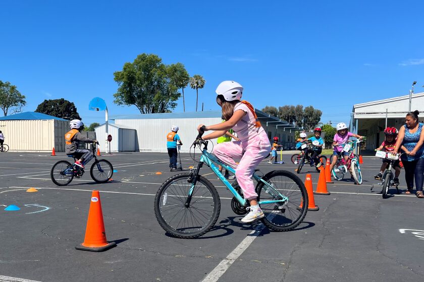 Kids learn bike safety on a Walk n' Rollers skills course at Wilson Elementary on May 2022.