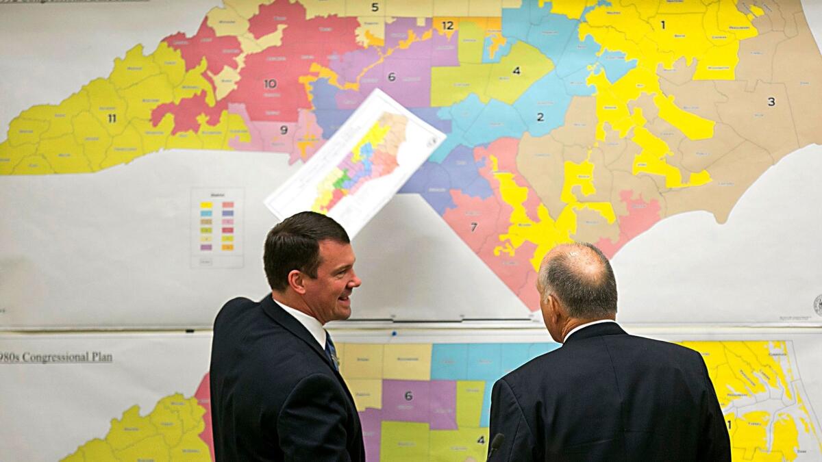 North Carolina Republican state Sens. Dan Soucek, left, and Brent Jackson review historical district maps in Raleigh on Feb. 16, 2016.