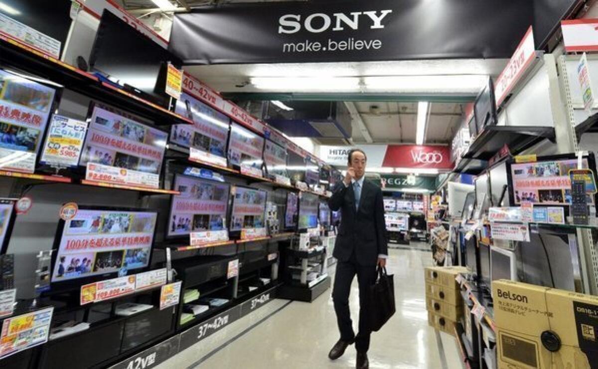 A man browses the TV set aisle in a Sony store in Tokyo. Sen. John McCain wants Americans to be able to unbundle their cable TV choices.