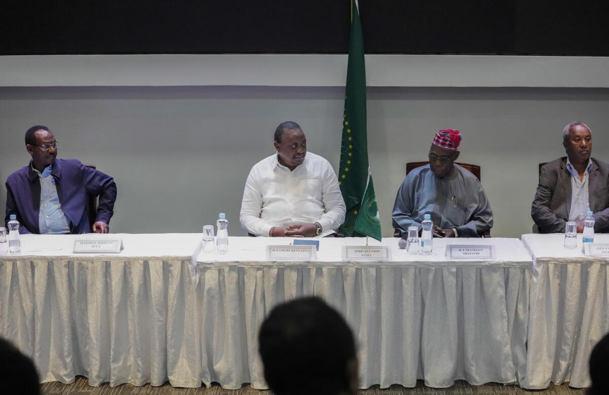 From left to right, Chief of Staff of Ethiopian Armed Forces Field Marshall Birhanu Jula, former Kenyan president Uhuru Kenyatta, African Union envoy and former Nigerian president Olesegun Obasanjo, and Head of the Tigray Forces Lieutenant General Tadesse Werede, attend continuing peace talks between Ethiopia's government and Tigray regional representatives, in Nairobi, Kenya Monday, Nov. 7, 2022. A new round of talks began Monday to work out military and other details of last week's signing of a "permanent" cessation of hostilities in a two-year conflict thought to have killed hundreds of thousands of people. (AP Photo/Khalil Senosi)