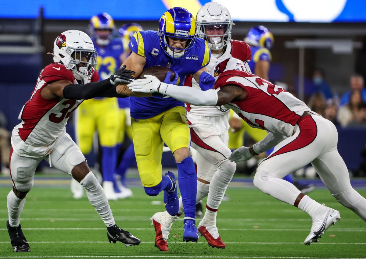 Rams wide receiver Cooper Kupp tries to break past Arizona's Chris Banjo and Deionte Thompson.