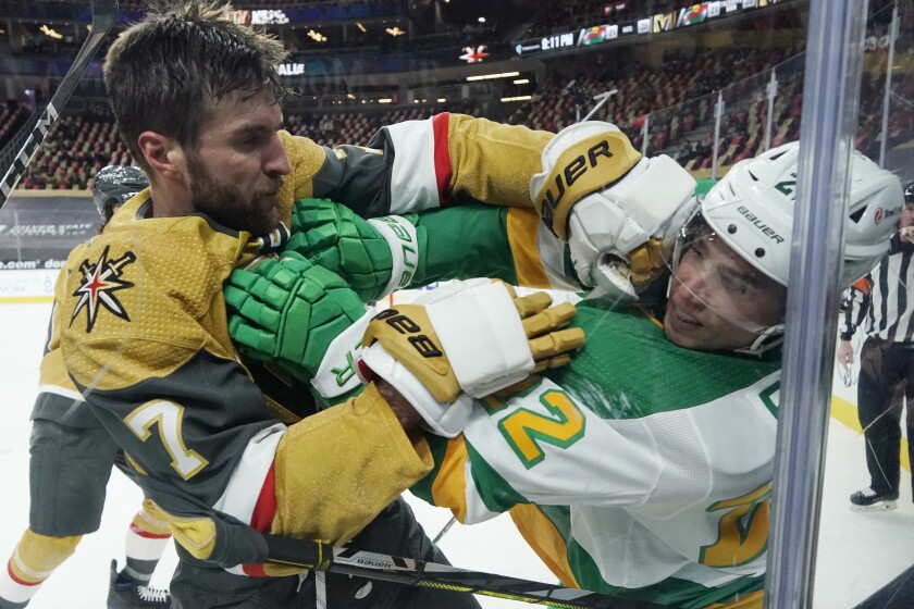 Vegas Golden Knights defenseman Alex Pietrangelo (7) and Minnesota Wild left wing Kevin Fiala (22) fight during the third period of an NHL hockey game Wednesday, March 3, 2021, in Las Vegas. (AP Photo/John Locher)