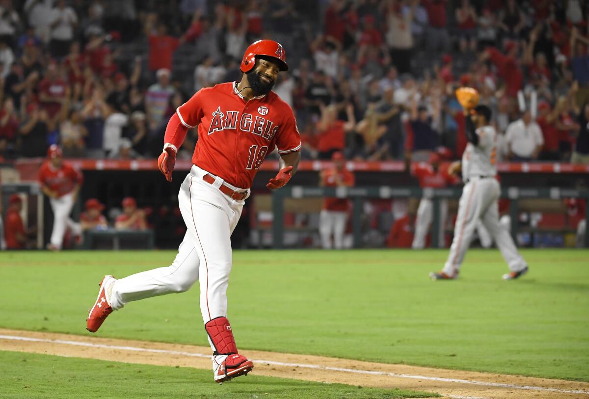 Angels' Brian Goodwin rounds first after hitting a ninth-inning solo home run.