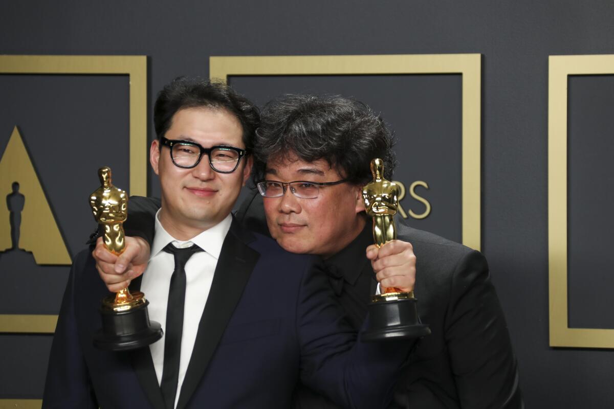 Han Jin Won and Bong Joon Ho, winners of the original screenplay Oscar for “Parasite,” in the Photo Room at the 92nd Academy Awards.