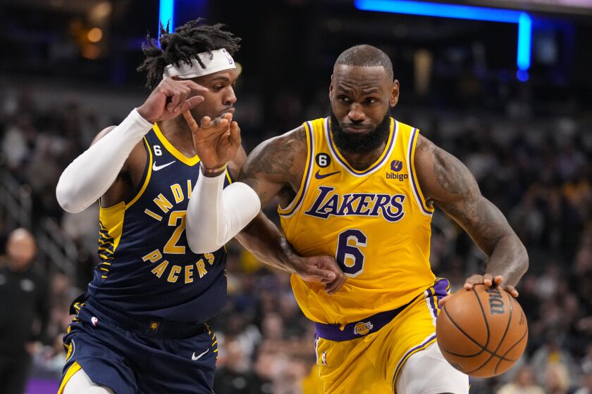Los Angeles Lakers forward LeBron James (6) drives on Indiana Pacers guard Buddy Hield (24) during the first half of an NBA basketball game in Indianapolis, Thursday, Feb. 2, 2023. (AP Photo/Michael Conroy)