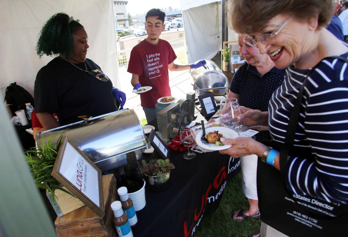Guests try the food from the Luna Grill during the 17th annual Wine & Food tasting event hosted by the Kiwainis Club of La Cañada, at Olberz Park on Sept. 22. Columnist Joe Puglia writes of the event this week.