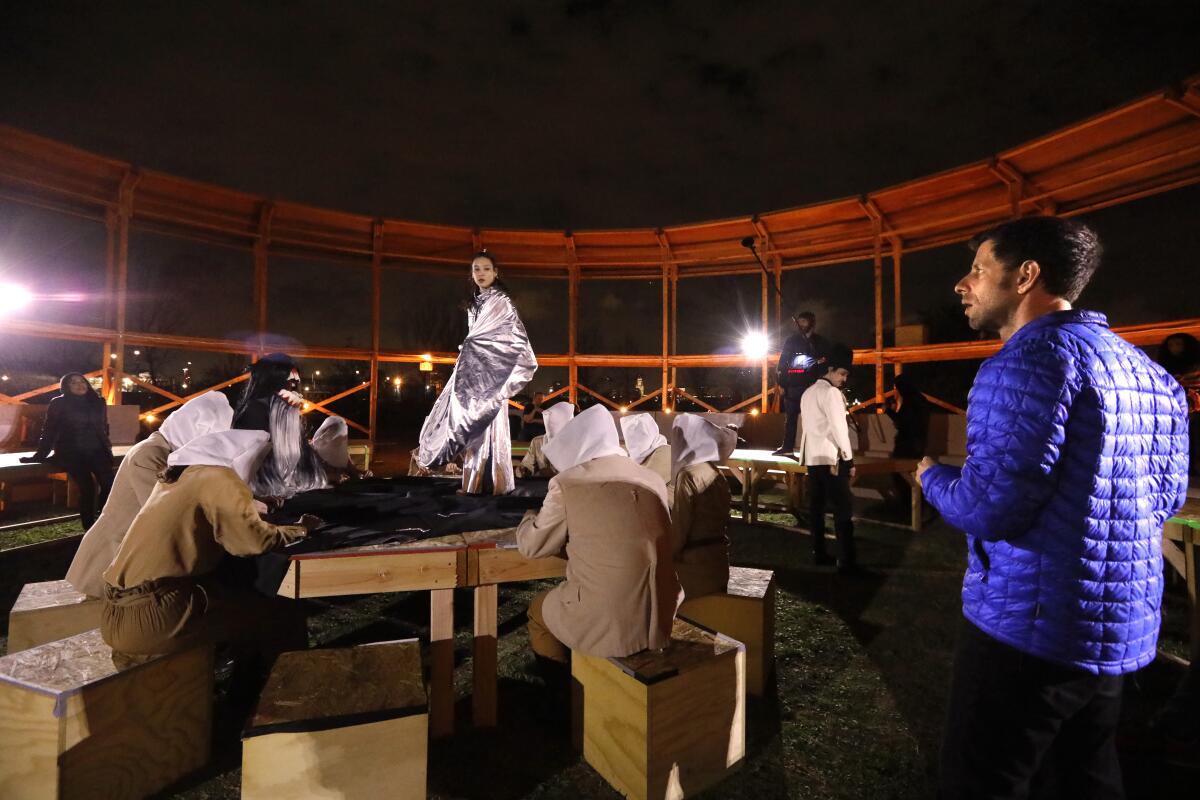 Kelci Hahn, center, and other performers with The Industry rehearse a scene from, ”Sweet Land," under the artistic direction of Yuval Sharon, right, at Los Angeles State Historic Park on February 21, 2020.  