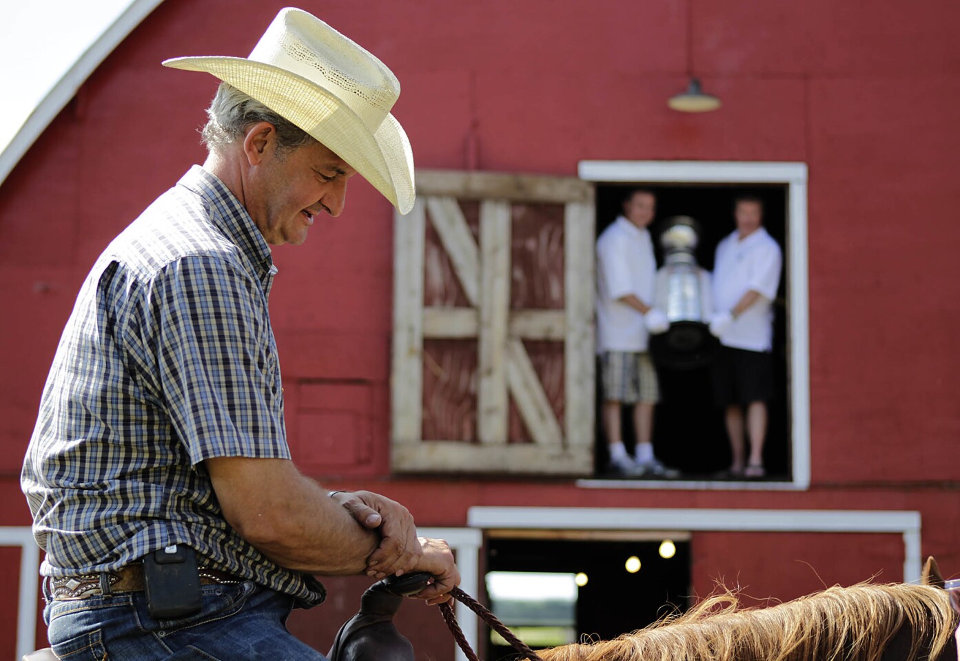 In Canada, you know that hockey is never going to be far away. Even down on the farm. In this image from 2012, the background shows Stanley Cup keepers Mike Bolt, right, and Howard Borrow in a barn doorway with hockey's greatest prize. In the foreground, Los Angeles Kings coach Darryl Sutter rides by on his horse, Red. Sutter's farm is near the small town of Viking, Alberta.