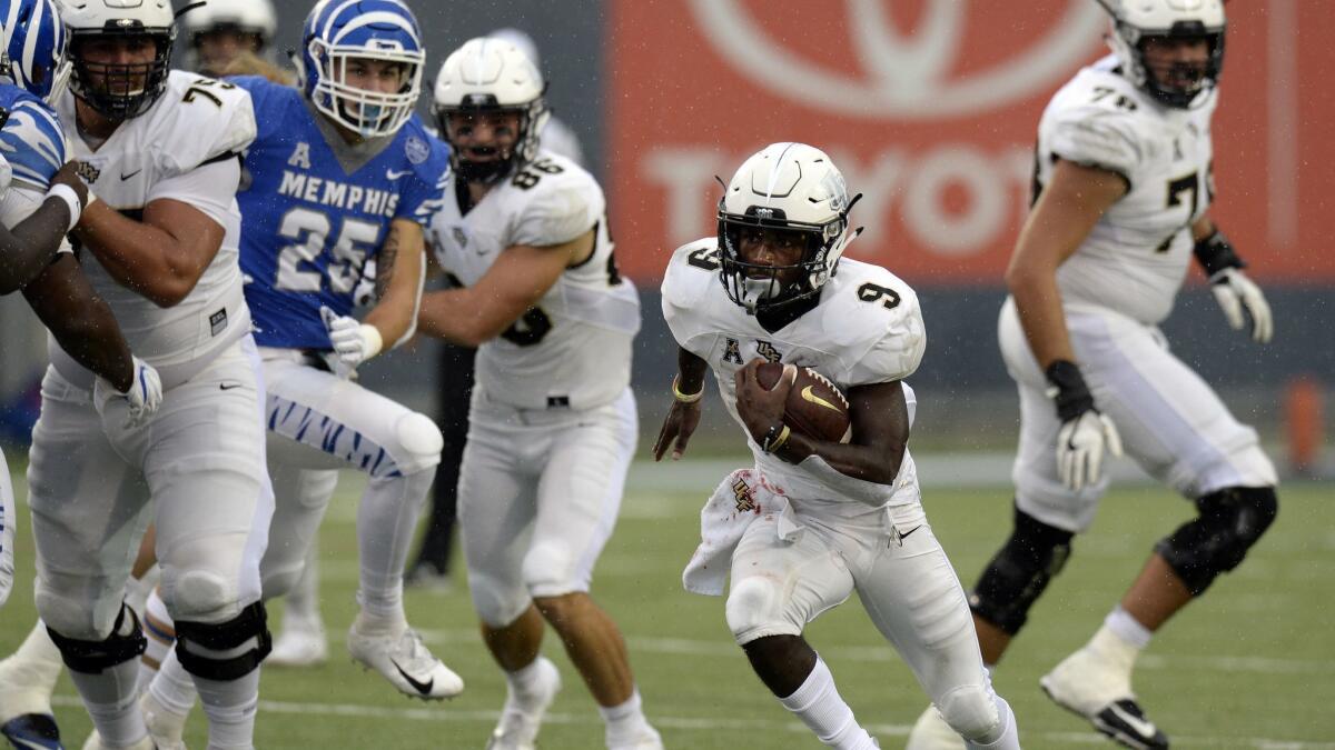 Central Florida running back Adrian Killins Jr. (9) runs the ball against Memphis during the second half on Oct. 13. Central Florida won 31-30.
